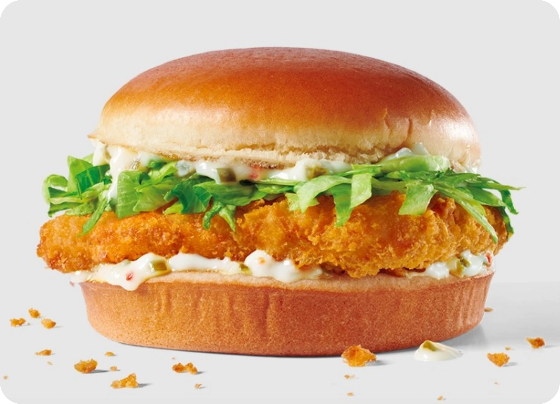 Crispy fried chicken sandwich with lettuce and mayo on a soft bun.